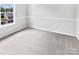 An Empty bedroom showcasing clean lines, neutral carpet, and natural light from a window at 752 Raindrops Rd, Gastonia, NC 28054