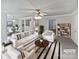 Bright living room featuring modern decor, striped rug, ceiling fan, and seamlessly connected dining area at 752 Raindrops Rd, Gastonia, NC 28054