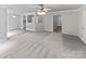 Neutral living space showcasing carpet, ceiling fan, and a view into the adjacent kitchen at 752 Raindrops Rd, Gastonia, NC 28054
