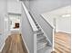 Carpeted staircase with white railing leading to an open-concept living area and adjoining rooms at 752 Raindrops Rd, Gastonia, NC 28054