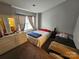 This bedroom includes a full size bed and dresser with natural light streaming through the windows at 7562 Petrea Ln, Charlotte, NC 28227
