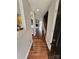 Inviting hallway with beautiful hardwood floors leads to a bright living space with a fireplace and staircase at 7562 Petrea Ln, Charlotte, NC 28227