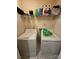 A laundry room features a washer, dryer, storage shelf and utility sink ready for everyday use at 7562 Petrea Ln, Charlotte, NC 28227