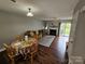 Spacious living room with hardwood floors, a fireplace, and a dining area, perfect for entertaining and relaxation at 7562 Petrea Ln, Charlotte, NC 28227
