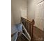 A stairway features brown carpet, white risers, and a wooden handrail with black wrought iron balusters at 7562 Petrea Ln, Charlotte, NC 28227