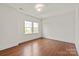 Neutral bedroom with hardwood floors and a bright window, providing a comfortable and inviting space at 7913 Waverly Walk Ave, Charlotte, NC 28277