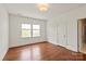 Bedroom with hardwood floors, bright window, and closet, offering a cozy retreat at 7913 Waverly Walk Ave, Charlotte, NC 28277