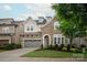 Charming stone and siding two-story home with a two-car garage and well-manicured lawn at 7913 Waverly Walk Ave, Charlotte, NC 28277