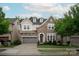 Charming stone and siding two-story home with a two-car garage and well-manicured lawn at 7913 Waverly Walk Ave, Charlotte, NC 28277