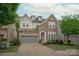 Charming stone and siding two-story home with a two-car garage and well-manicured lawn at 7913 Waverly Walk Ave, Charlotte, NC 28277