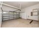 Spacious garage with epoxy flooring, storage cabinets, and ample room for vehicles and projects at 7913 Waverly Walk Ave, Charlotte, NC 28277
