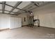 Garage with epoxy flooring, storage cabinets, and ample space for storage or vehicles at 7913 Waverly Walk Ave, Charlotte, NC 28277