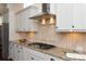 Gourmet kitchen featuring granite countertops, tile backsplash, stainless steel hood, and modern white cabinetry at 7913 Waverly Walk Ave, Charlotte, NC 28277