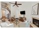 Spacious living area featuring a staircase, fireplace, and mounted TV at 7913 Waverly Walk Ave, Charlotte, NC 28277
