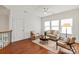 Cozy living room features hardwood floors, neutral furniture, and a ceiling fan for added comfort at 7913 Waverly Walk Ave, Charlotte, NC 28277