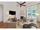 Cozy living room features a fireplace, large windows, and comfortable seating at 7913 Waverly Walk Ave, Charlotte, NC 28277