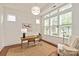 Well-lit home office with large windows, hardwood floors, and stylish decor at 7913 Waverly Walk Ave, Charlotte, NC 28277