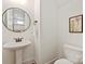 Cozy powder room with pedestal sink and framed art, offering a convenient space at 7913 Waverly Walk Ave, Charlotte, NC 28277