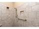 Elegant tile shower with built in showerhead and safety bar offers a modern retreat at 7913 Waverly Walk Ave, Charlotte, NC 28277