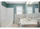 Clean bathroom featuring tiled walls and floors, a tub/shower combo, window, sink and white vanity at 800 Old Little Rock Rd, Charlotte, NC 28214
