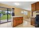 An open kitchen with wood cabinets, an island, a sliding glass door and view to the living room at 800 Old Little Rock Rd, Charlotte, NC 28214