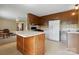 Vintage kitchen with an island, wood cabinetry, and white appliances; view to the living room at 800 Old Little Rock Rd, Charlotte, NC 28214