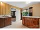 Retro kitchen with wood cabinets, an island and a view to the outside at 800 Old Little Rock Rd, Charlotte, NC 28214