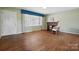 Cozy living room featuring hardwood floors, a brick fireplace, and large window at 800 Old Little Rock Rd, Charlotte, NC 28214