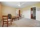 Inviting living room with neutral carpet, ceiling fan, and view to other areas of the house at 800 Old Little Rock Rd, Charlotte, NC 28214