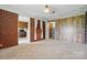 Living room featuring brick accent wall and access to the kitchen and storage at 800 Old Little Rock Rd, Charlotte, NC 28214