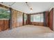Bright living room featuring paneled walls, neutral carpet, and natural light at 800 Old Little Rock Rd, Charlotte, NC 28214