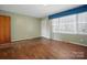 Bright living room features hardwood floors, a large window, and neutral paint at 800 Old Little Rock Rd, Charlotte, NC 28214