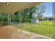 An exterior porch with a grassy yard, shed and forest in the background at 800 Old Little Rock Rd, Charlotte, NC 28214