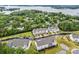Gorgeous aerial view overlooking townhomes, lush greenery, and a picturesque lake at 8215 Houser St, Cornelius, NC 28031