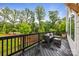 Exterior view of a deck with comfortable outdoor seating and beautiful trees in the background at 8215 Houser St, Cornelius, NC 28031