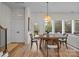 Bright dining room features a wood table, stylish chairs, and a modern pendant light fixture at 8215 Houser St, Cornelius, NC 28031