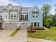Charming townhome showcasing craftsman-style architecture, a 2-car garage, and a landscaped yard at 8215 Houser St, Cornelius, NC 28031