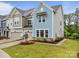 Beautiful townhome showcasing attractive siding, stone accents, manicured lawn, and an attached garage at 8215 Houser St, Cornelius, NC 28031