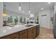 Bright kitchen island with a white countertop and a sink overlooking the living area at 8215 Houser St, Cornelius, NC 28031