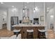 Modern kitchen with an island, pendant lighting, stainless steel appliances, and white cabinetry at 8215 Houser St, Cornelius, NC 28031