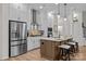 Modern kitchen with an island, pendant lighting, stainless steel appliances, and white cabinetry at 8215 Houser St, Cornelius, NC 28031