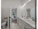 Main bathroom with double sinks, a large mirror and views of the bedroom at 8215 Houser St, Cornelius, NC 28031