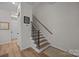 Stairway with carpeted treads and wood handrail leading to the upper level at 8215 Houser St, Cornelius, NC 28031