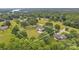 Aerial view of a home with a spacious yard surrounded by lush greenery and mature trees at 827 River Hills Ct, Taylorsville, NC 28681