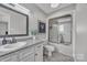 This bathroom has a vanity with granite countertops, a framed mirror, and a tiled tub-shower combo at 827 River Hills Ct, Taylorsville, NC 28681