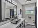 This stylish bathroom features modern fixtures, a vessel sink, and sleek black and white herringbone tile shower at 827 River Hills Ct, Taylorsville, NC 28681