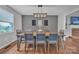 Elegant dining room with a modern light fixture, stylish decor, and seating for eight guests at 827 River Hills Ct, Taylorsville, NC 28681