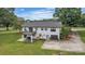 Rear view of the home highlighting the garage and balcony on a well-maintained lawn at 827 River Hills Ct, Taylorsville, NC 28681
