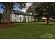 Charming exterior view of the home with curb appeal, large lawn and mature shade trees at 827 River Hills Ct, Taylorsville, NC 28681