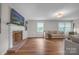 Inviting living room with hardwood floors, fireplace, and plenty of natural light at 827 River Hills Ct, Taylorsville, NC 28681